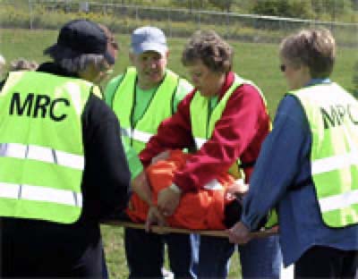 Medical Reserve Corps volunteers in yellow vests