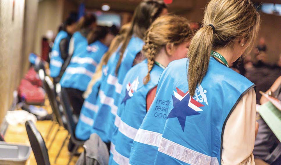 Medical Reserve Corps volunteers in blue vests